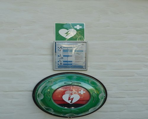 Person holding a green heart symbol representing health awareness